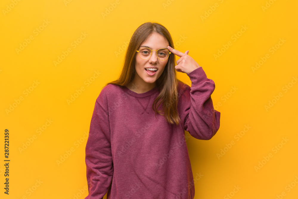 Obraz premium Young casual woman doing a disappointment gesture with finger