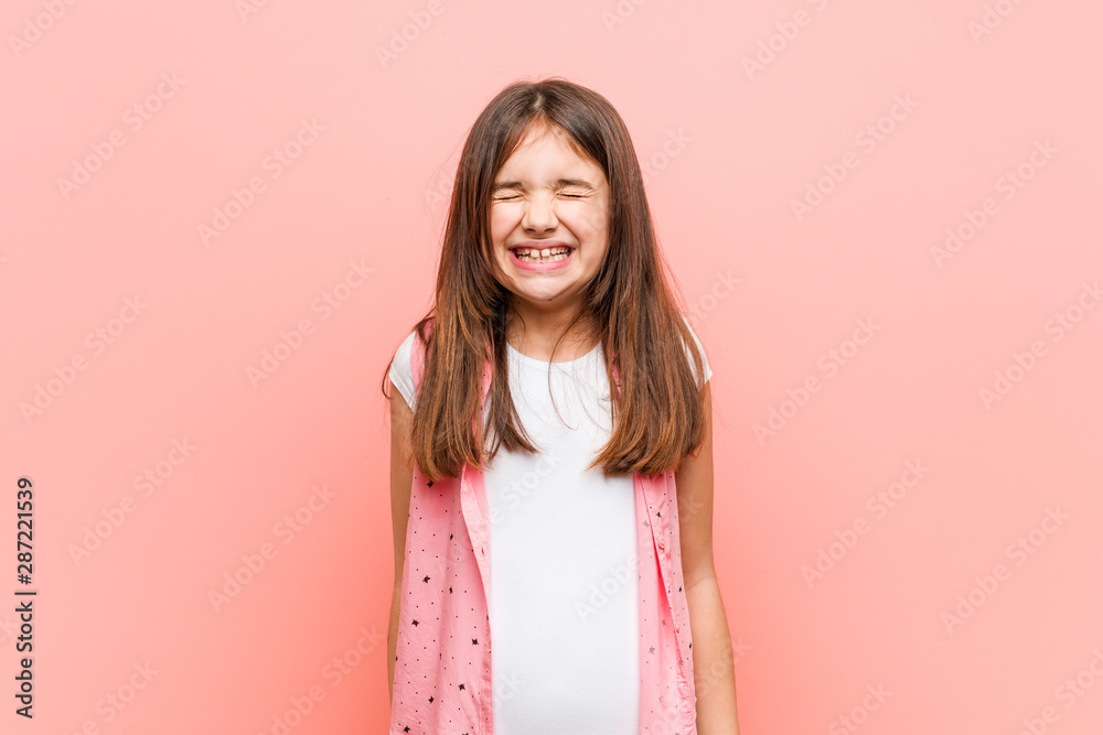 Cute little girl laughs and closes eyes, feels relaxed and happy. Cute little girl laughs and closes eyes, feels relaxed and happy.