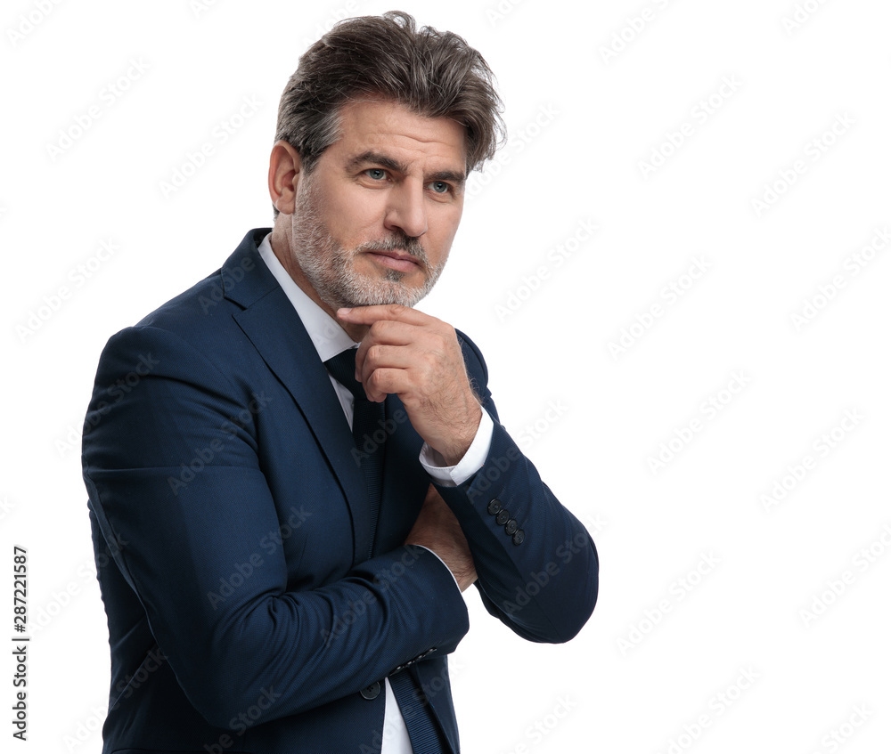 Thoughtful businessman holding his hand on his chin Thoughtful businessman holding his hand on his chin