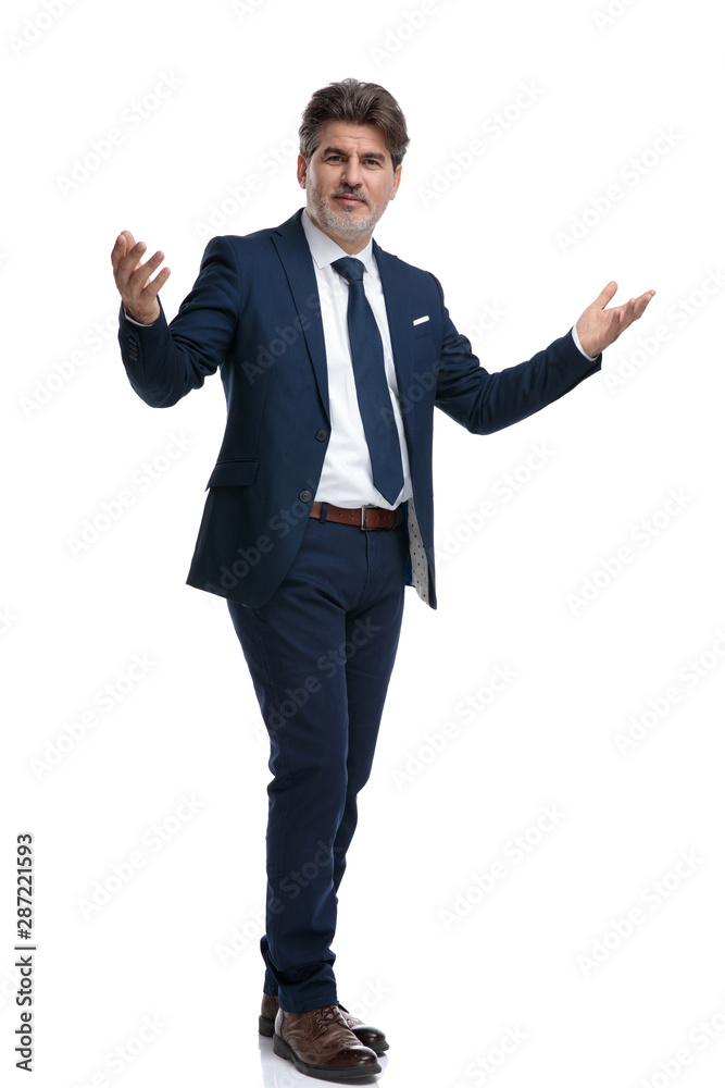 Positive businessman greeting with his arms wide open Positive businessman greeting with his arms wide open