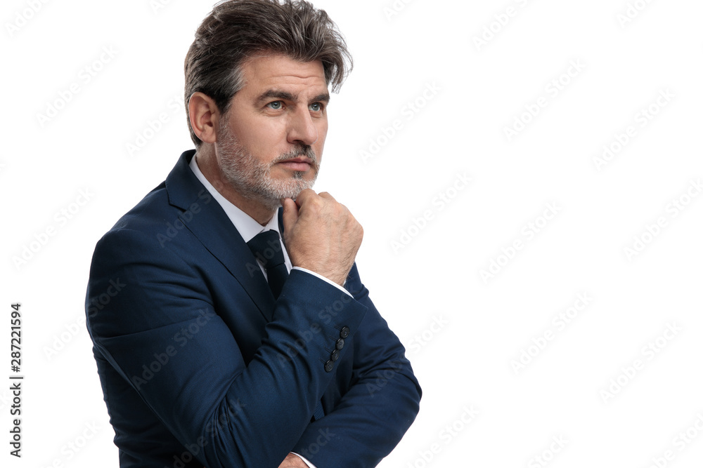 Wondering businessman hopefully looking away Wondering businessman hopefully looking away