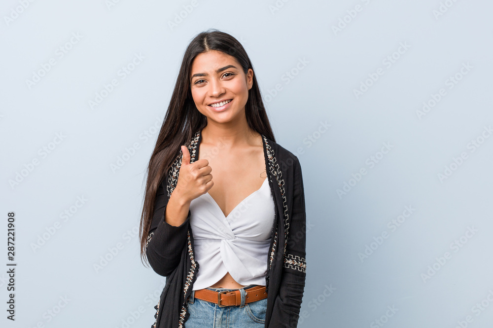 Young natural and pretty arab woman smiling and raising thumb up Young natural and pretty arab woman smiling and raising thumb up