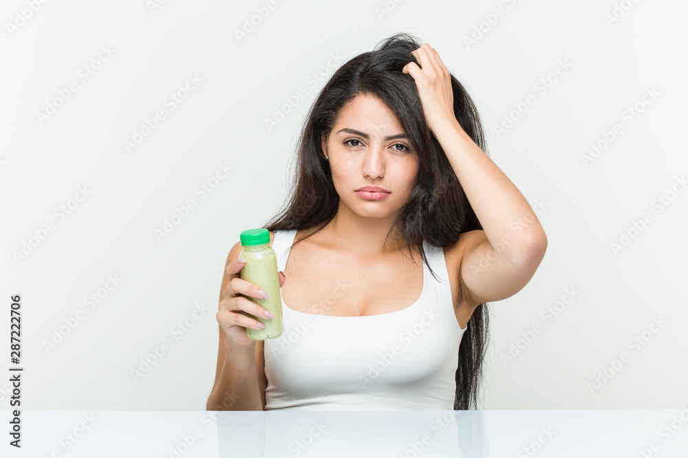 Young hispanic woman holding a vegetable drink being shocked, she has remembered important meeting. Young hispanic woman holding a vegetable drink being shocked, she has remembered important meeting.