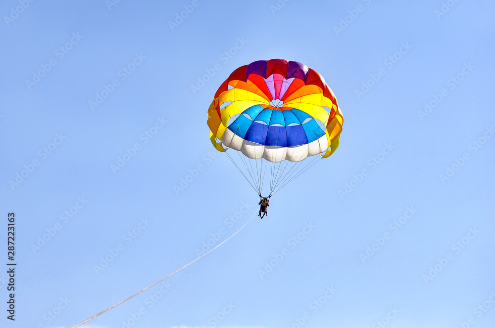 Para sailing using a parachute on background of blue sky. Para sailing using a parachute on background of blue sky.