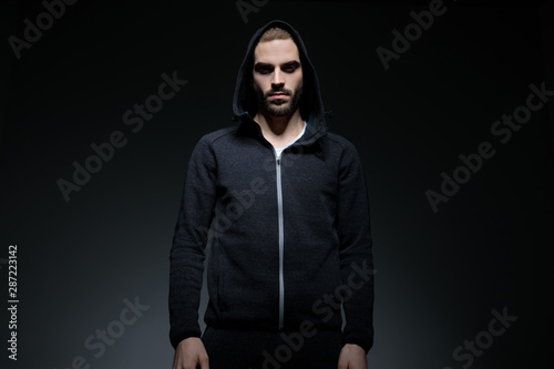 cool sporty man wearing hood on