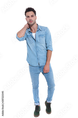 confident man dressed in denim posing with hand behind neck © Viorel Sima
