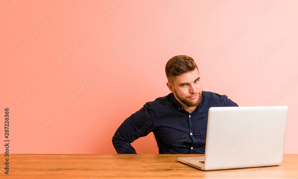 Young man working with his laptop scolding someone very angry. Young man working with his laptop scolding someone very angry.