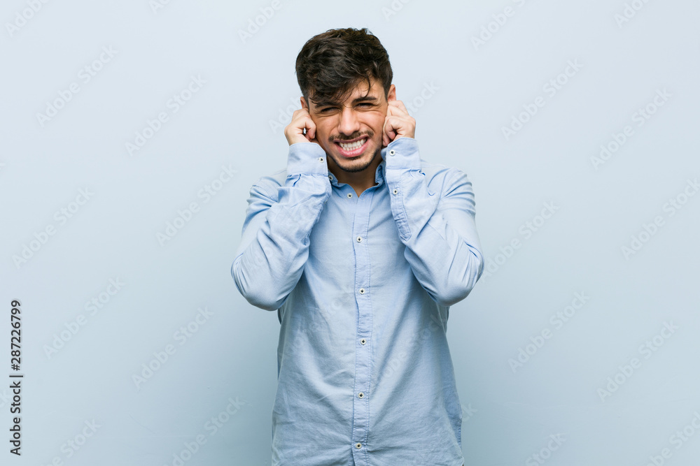 Young hispanic business man covering ears with hands. Young hispanic business man covering ears with hands.