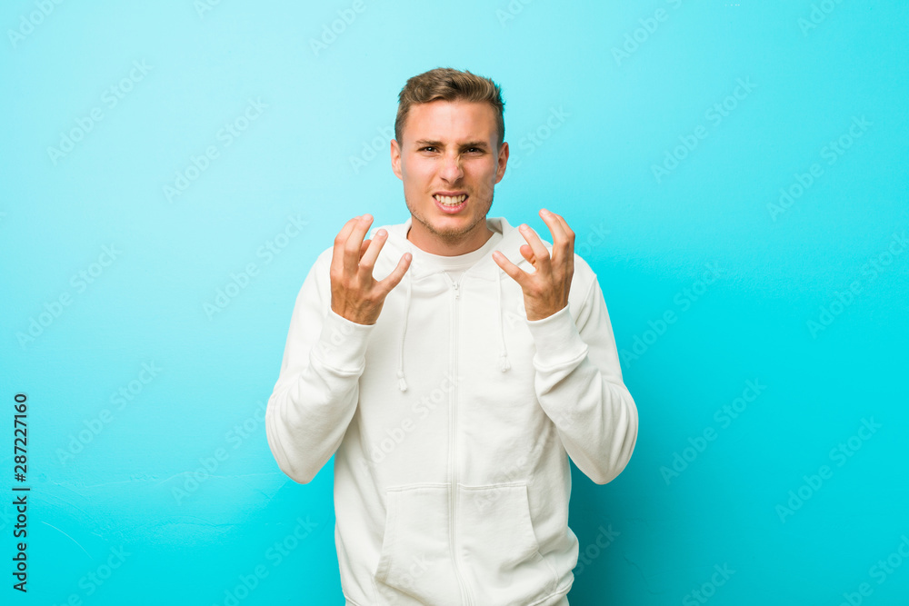 Young caucasian sport man upset screaming with tense hands. Young caucasian sport man upset screaming with tense hands.