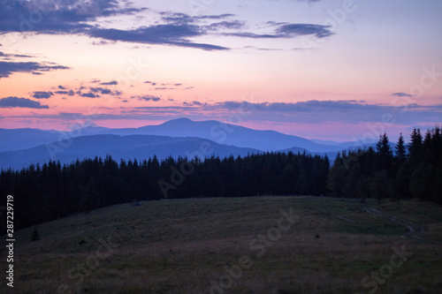 Fototapeta Naklejka Na Ścianę i Meble -  red-blue sunset haze in the mountain gorge, orange-blue sunset in the mountains