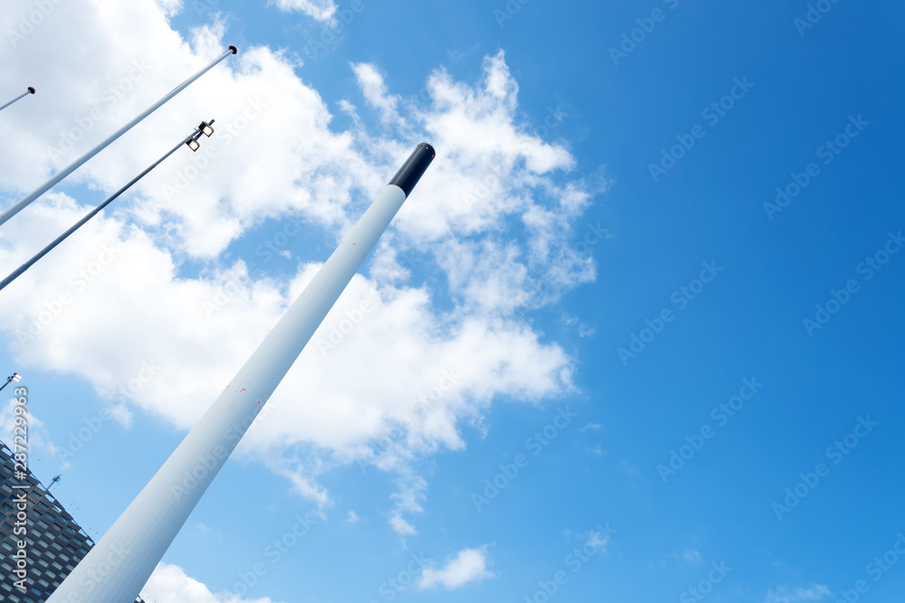 Smokestack against the blue sky. Bottom view Industrial background. Architecture. Smokestack against the blue sky. Bottom view Industrial background. Architecture.
