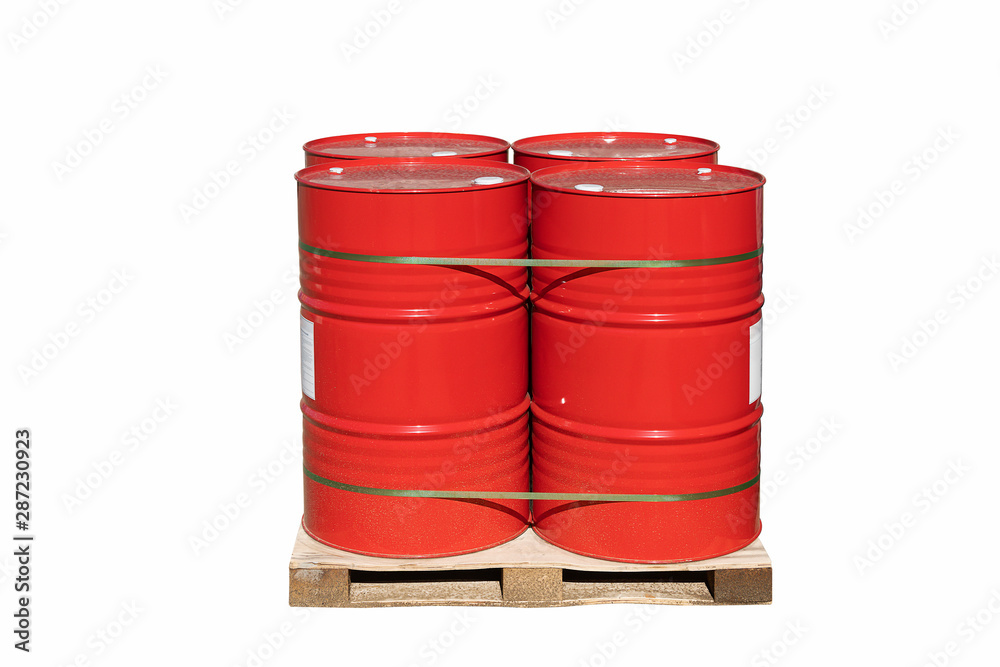 Four red barrels of 200 liters for liquid. Barrels stand on a pallet. Hazardous liquid in steel barrels. Isolated background.