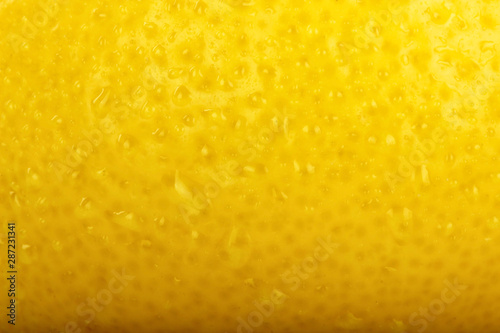 fresh rind of yellow lemon with water drops background design