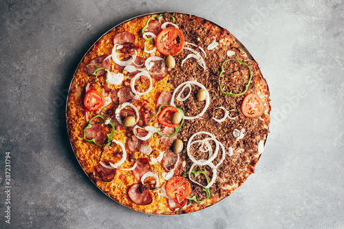 Flat lay of delicious pizza on gray background