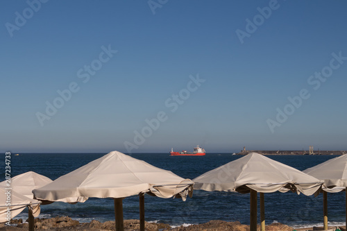 Sun umbrellas and Atlantic ocean © yassmin