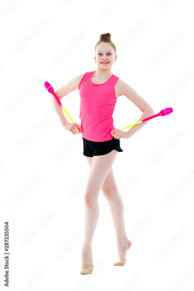 A girl gymnast performs exercises with a mace. A girl gymnast performs exercises with a mace.