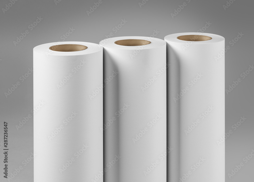 Blank white paper rolls isolated on gray background. Mockup paper for magazines, catalogs or newspapers isolated on gray backdrop, Printing house theme or wrapping paper for presents Blank white paper rolls isolated on gray background. Mockup paper for magazines, catalogs or newspapers isolated on gray backdrop, Printing house theme or wrapping paper for presents