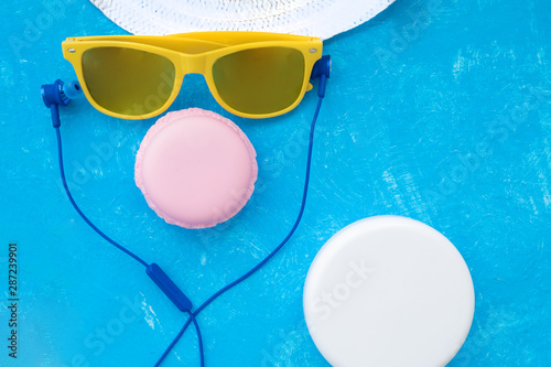 woman holding sunglasses on bright background, cosmetic summer concept