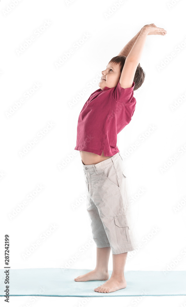 little boy performs an exercise the bridge .isolated on white little boy performs an exercise the bridge .isolated on white