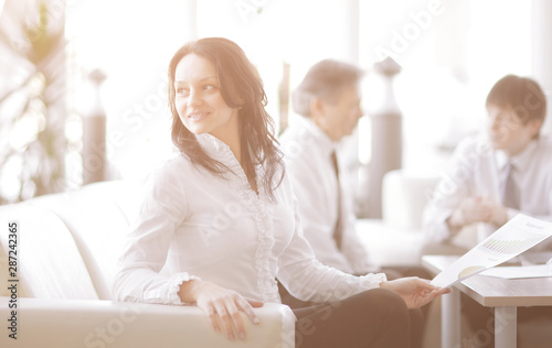 portrait of business woman on the background of colleagues