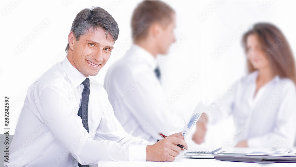 Smiling businessman and businesswoman shaking hands over conference table Smiling businessman and businesswoman shaking hands over conference table