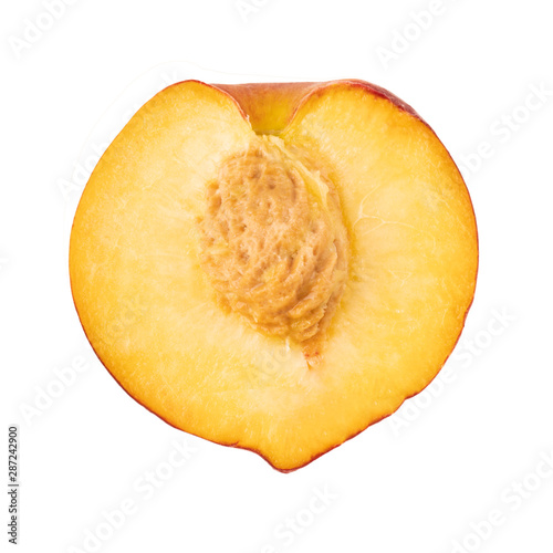 half fresh peach with stone isolated on white background