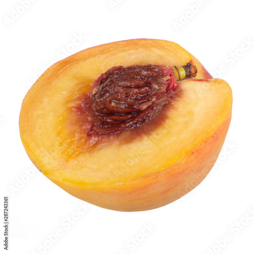 half fresh peach with stone isolated on white background