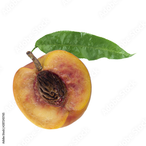 half fresh peach with green leaf isolated on white background