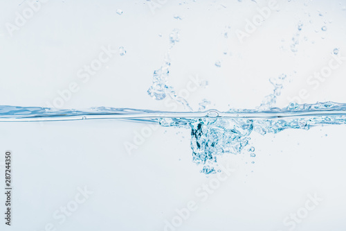 Water splash close up of splash of water forming shape isolated on white background.
