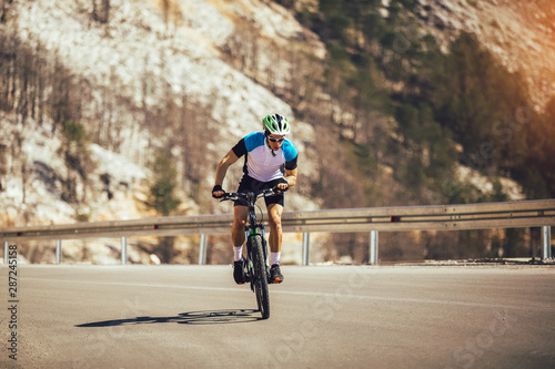 Man ride mountain bike on the road. Sport and active life concept.