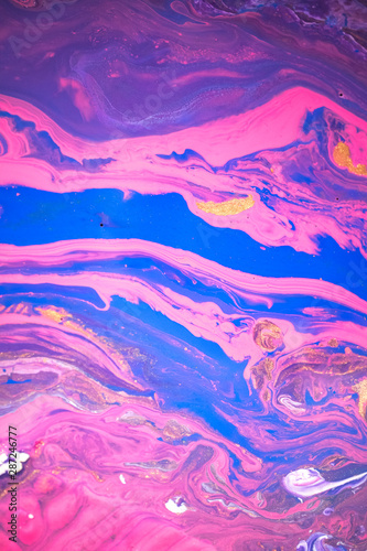 Abstract created using the technique of liquid acrylic. Macro photography of the smallest details of a picture. The picture shows how overflows of shades and colors of paint resemble space motifs. © Mari Dein