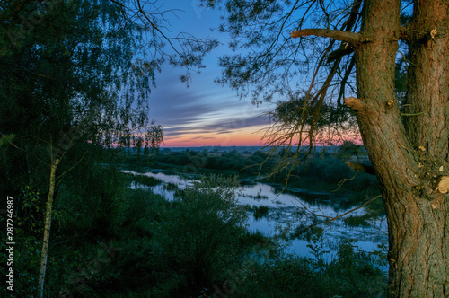 Sunset by the river. Uzh River, Zhytomyr Region, Ukraine. photo