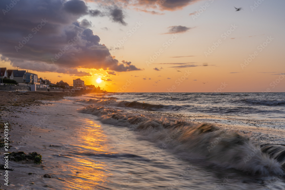 Obraz premium Luc-Sur-Mer, France - 08 12 2019: Beautiful sunset on the coast