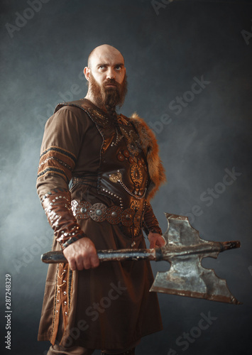Angry viking with axe, martial spirit, barbarian photo