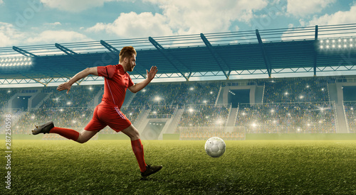Professional soccer player in action with the ball. Crowded soccer stadium with fans cheering © TandemBranding