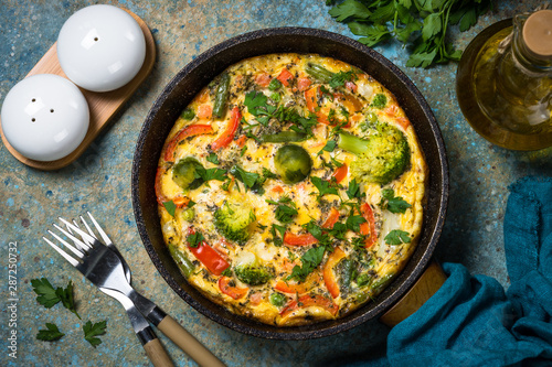 Frittata with fresh vegetables in the skillet.