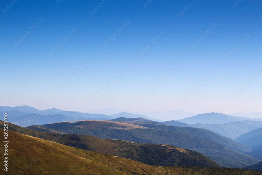 The mountains on the horizon in the rays of sunlight at sunset