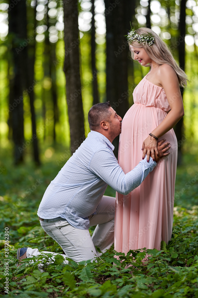 Fototapeta premium Pregnant wife and her husband outdoor
