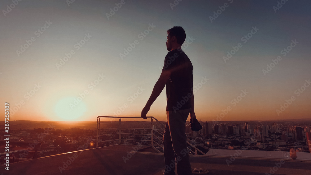 Photographer on top of the building at sunset Photographer on top of the building at sunset