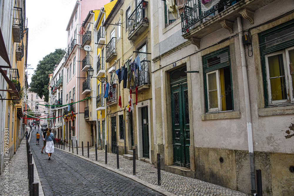 Lisbon, Portugal - July 27, 2019: A typical narrow streets in the Old Town of Alfama, Lisbon