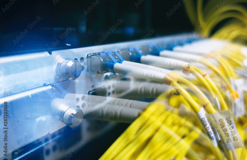 Close up fiber optic in server room , network cables installed in the rack. Close up fiber optic in server room , network cables installed in the rack.