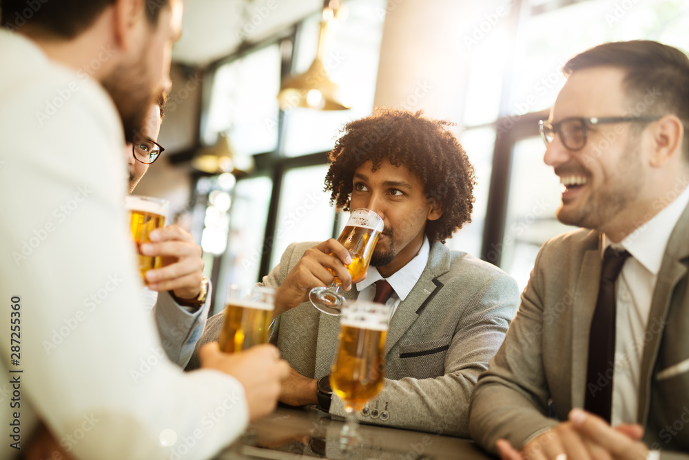 young businessmen after work in a pub young businessmen after work in a pub
