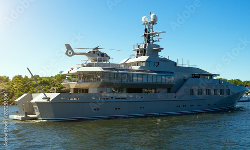 Private luxury ship with helipad in the coastal waters. © M-Production