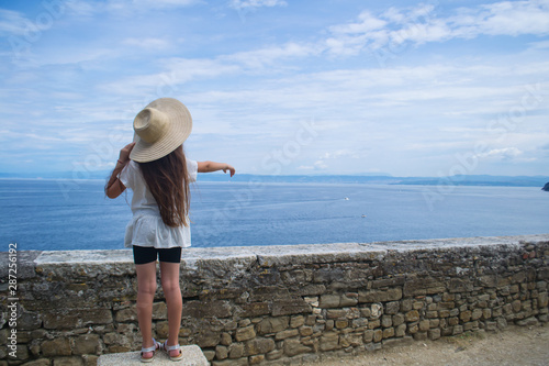 An young girl show the sea to her brother