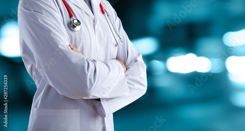 Doctor man in a white coat with a stethoscope on an abstract background