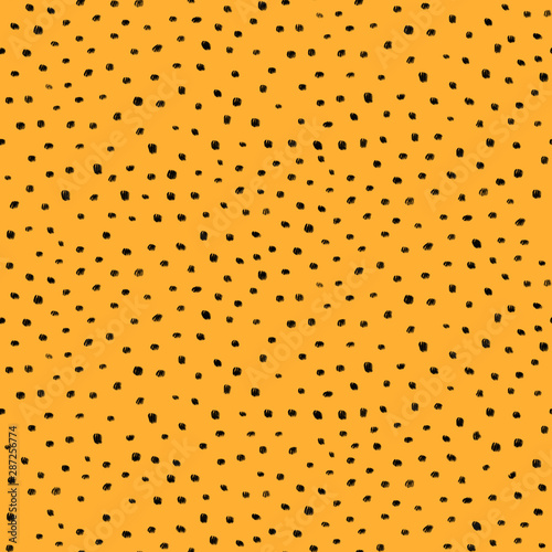 Abstract seamless pattern with black dots on orange background 