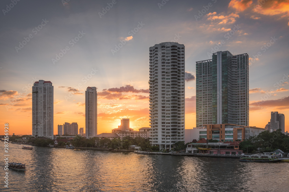 Sunset in the City of Bangkok, Thailand. Chao Phraya River Embankment with Skyscreapers.