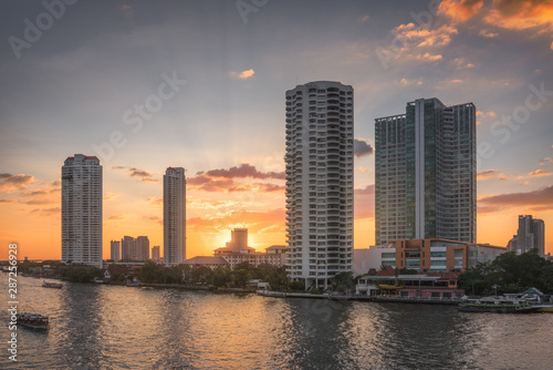 Sunset in the City of Bangkok, Thailand. Chao Phraya River Embankment with Skyscreapers. photo