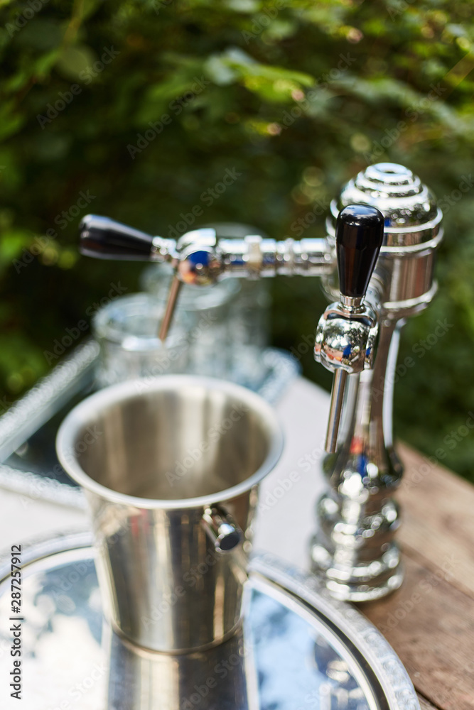 Silver beer dispenser close up. Liquid dispenser Silver beer dispenser close up. Liquid dispenser