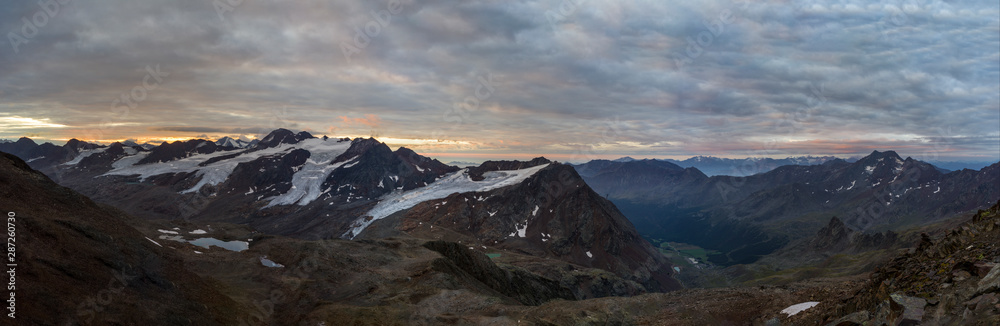 Panorama of sunrise above glacier in European Alps